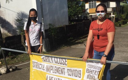 ONE ENTRY, ONE EXIT. Antique Liga ng mga Barangay president Pamela Socorro Azucena (right) implements the "one entry, one exit" in Barangay Idio, Sebaste to discourage people from going out of their homes. She said on Thursday (Aug. 26, 2021) she will call for a meeting with other barangay leaders in the province's 18 towns to discuss the uniform of the Covid-19 health protocols. (Photo courtesy of LnB Antique)